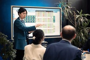 gerente-de-oficina-presentando-el-analisis-de-datos-y-la-financiacion-en-un-tablero-interactivo 1-1